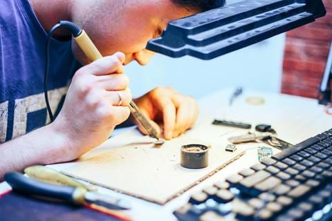 Image Of Engineer With Soldering Iron Repairing Me M8ZBGE8