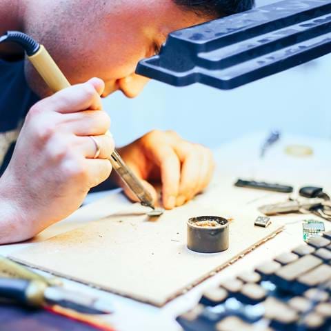 Image Of Engineer With Soldering Iron Repairing Me M8ZBGE8